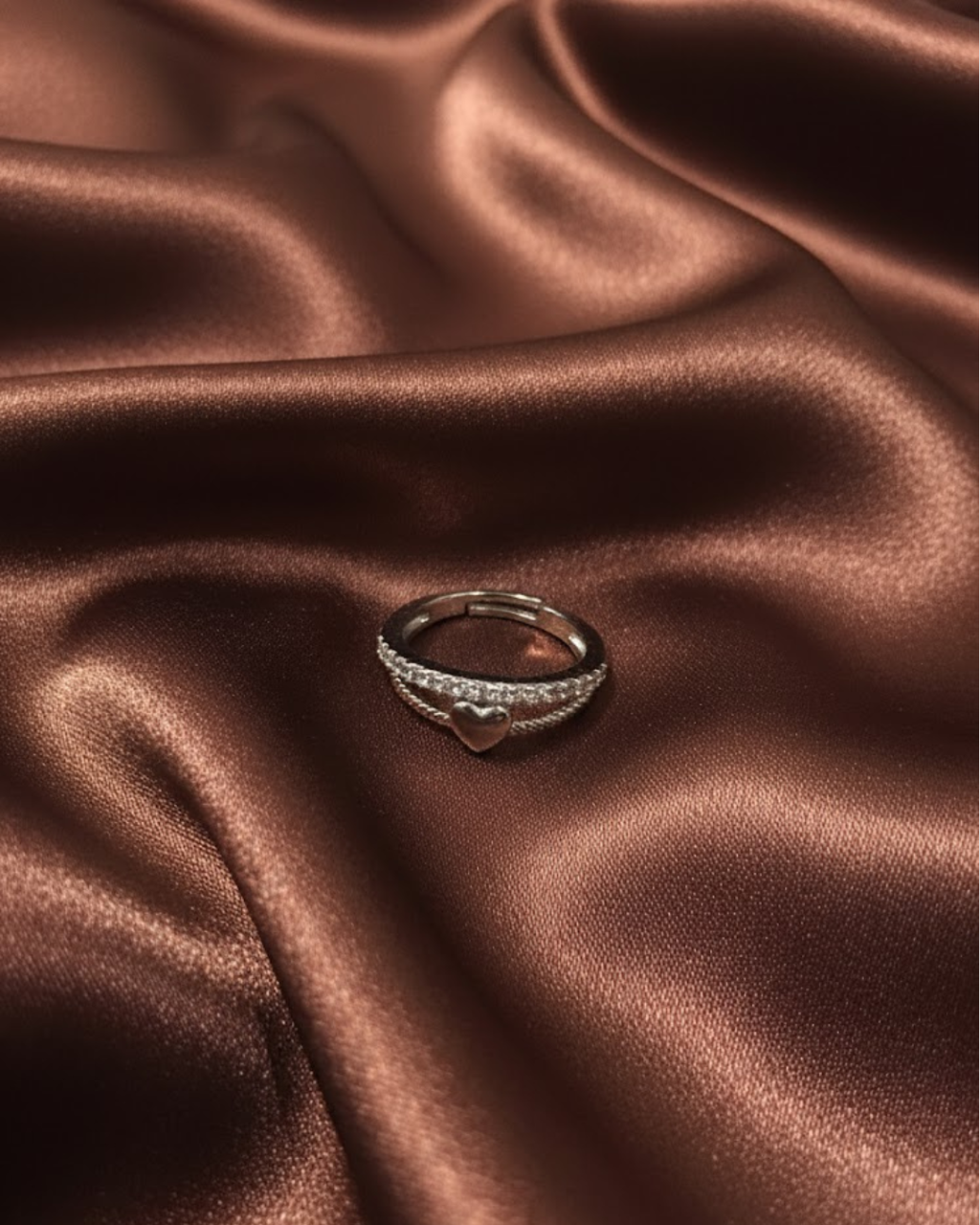 silver-plated adjustable ring with a heart charm and cubic zirconia stones