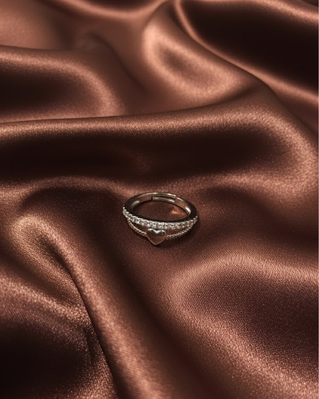 silver-plated adjustable ring with a heart charm and cubic zirconia stones