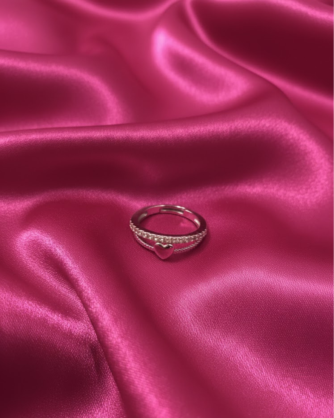 silver-plated adjustable ring with a heart charm and cubic zirconia stones