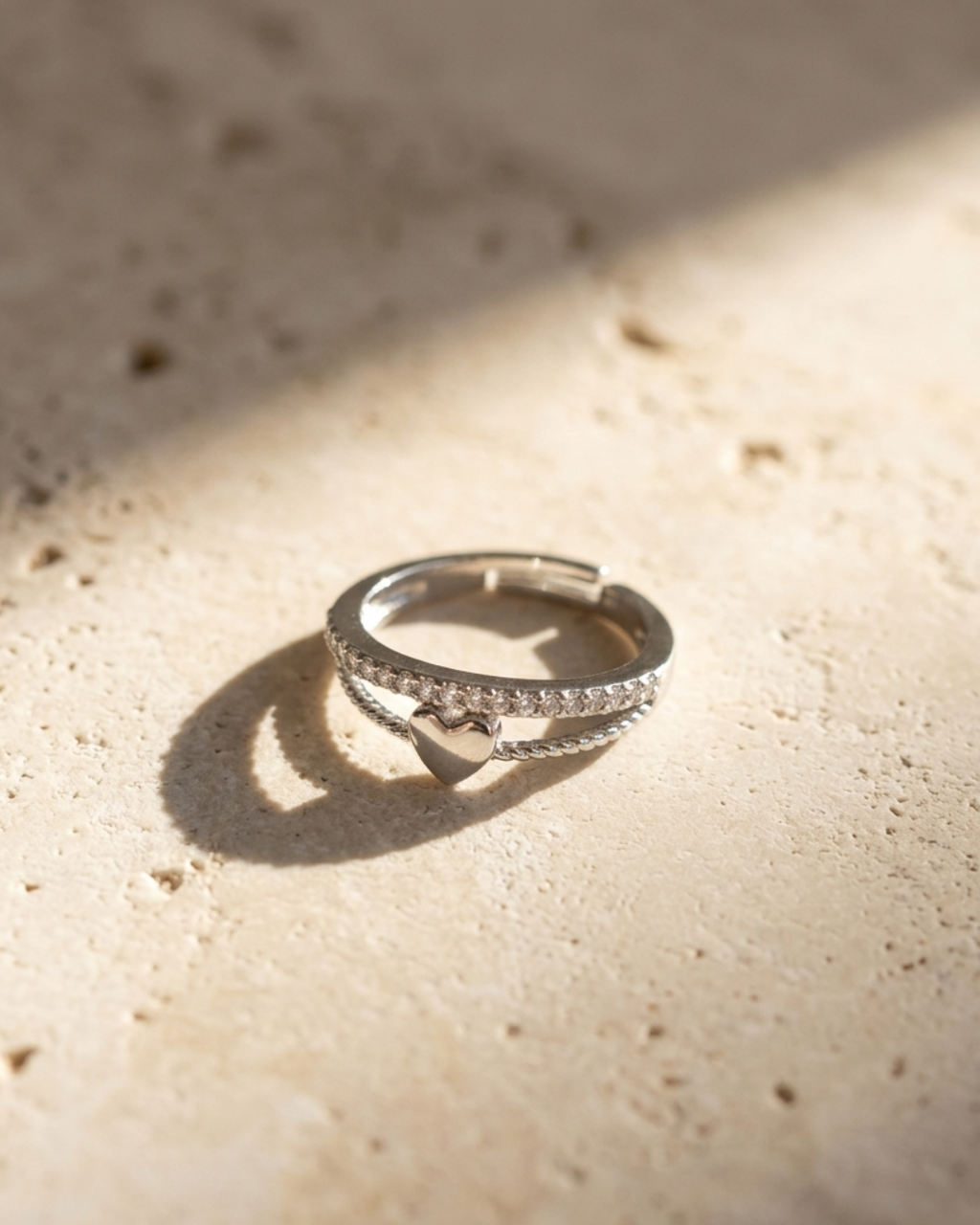 silver-plated adjustable ring with a heart charm and cubic zirconia stones